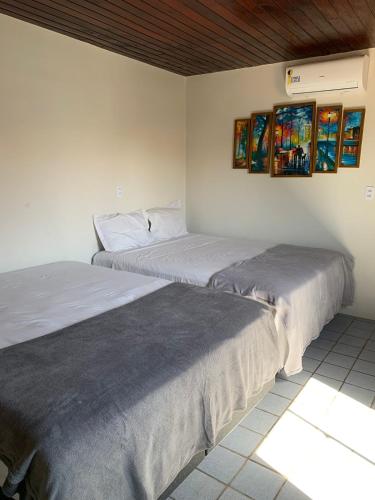 Ένα ή περισσότερα κρεβάτια σε δωμάτιο στο Pousada Caminho do Paraiso