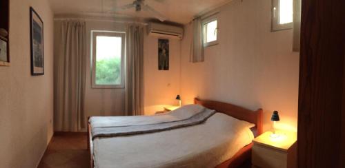 a bedroom with a bed and a window at Casa-Poseidon in Hvar