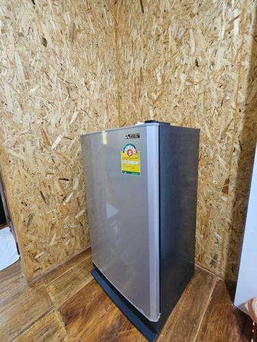 a stainless steel refrigerator in front of a wall at Easy Life Country House in Ko Lanta