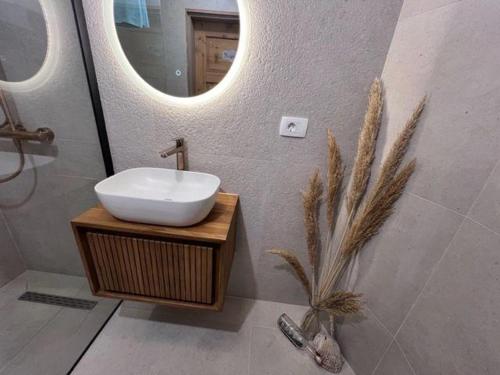 a bathroom with a sink and a mirror at Casa-Poseidon in Hvar