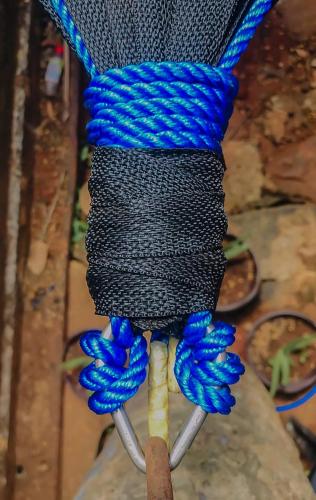 a blue and black rope with blue knots on a stick at Dolphin Village in Kalpitiya