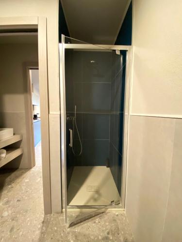 a glass shower in the corner of a bathroom at Apartments Du Parc in Sauze dʼOulx