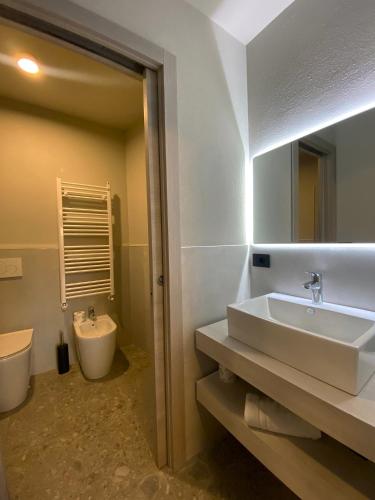 a bathroom with a sink and a toilet at Apartments Du Parc in Sauze dʼOulx