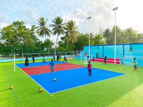 a group of people playing soccer on a field at Captal Beach Villa in Mathiveri