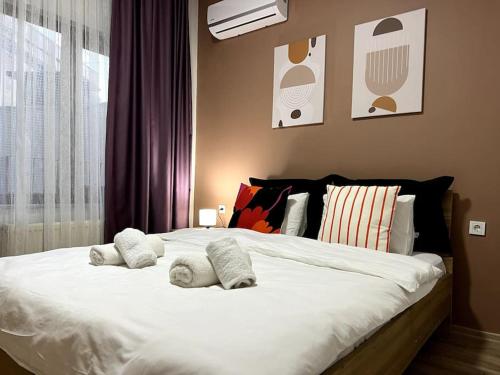 a bedroom with a large white bed with pillows at ComeLiveGO Cihangir 31 in Istanbul