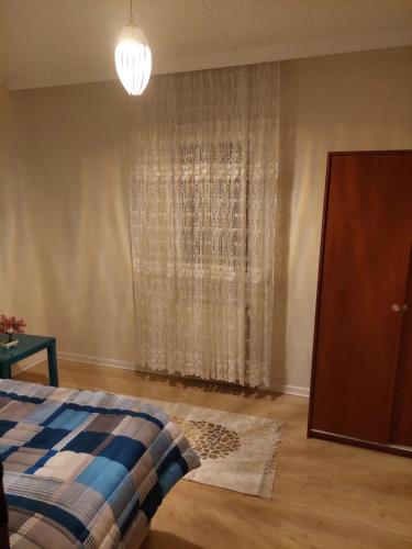 a bedroom with a bed and a window with curtains at F.A.A Sabiha Gökçen in Istanbul