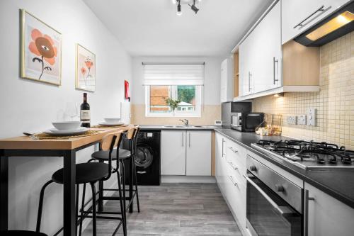 a kitchen with white cabinets and a counter top at Luxury 2 Bedroom Apartment - Parking - Nr Birmingham City Centre - 2WH - Top Rated in Birmingham