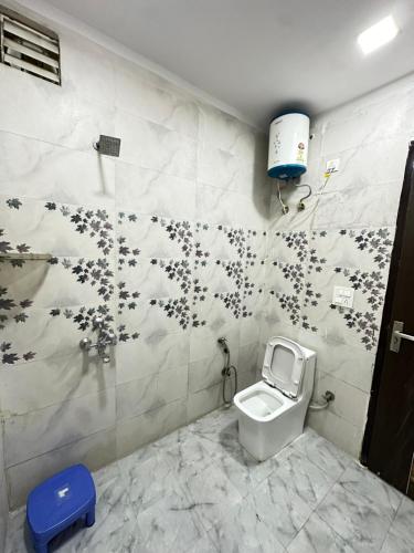 a bathroom with a toilet in a room at MB farms in Greater Noida