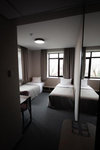 Postel nebo postele na pokoji v ubytování Zagorod Hotel