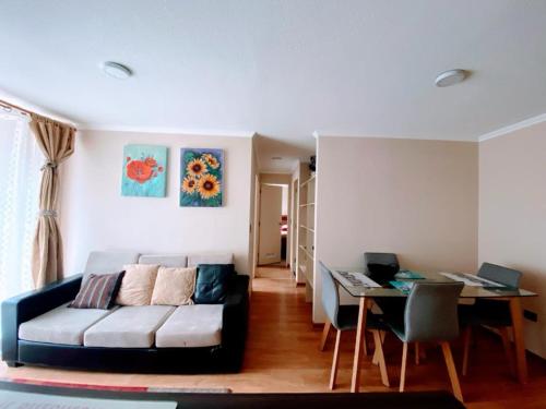 a living room with a couch and a table at Departamento Temuco Full Equipado in Temuco