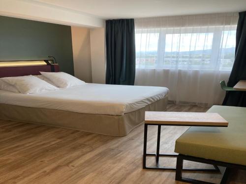 a hotel room with two beds and a window at Campanile Perpignan Aéroport in Rivesaltes