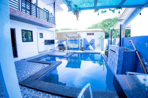 a swimming pool in the middle of a house at Villa Valencia Private Resort in Santa Rita