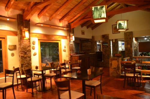 a restaurant with tables and chairs in a room at El Refugio de Coquena in Purmamarca