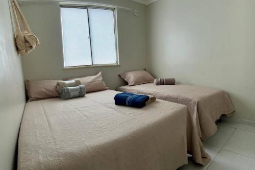 two beds sitting next to each other in a room at Apartamento Charmie in São Luís