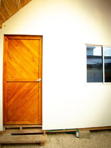 a wooden door of a house with a window at Mithival Beach Rincón del Mar in Rincón