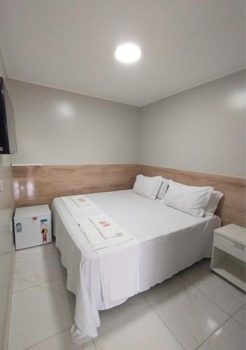 a bedroom with a large white bed in a room at Pousada Chapada do Araripe in Araripina