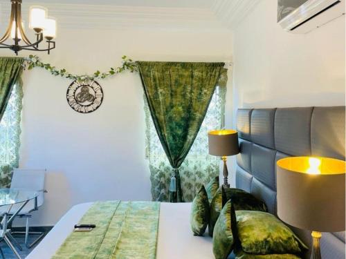 a bedroom with a bed and a table and a window at Perriman Hotel in Kokrobite