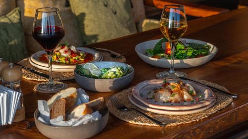 a table with plates of food and glasses of wine at La Boheme Kabak Adults Only in Faralya