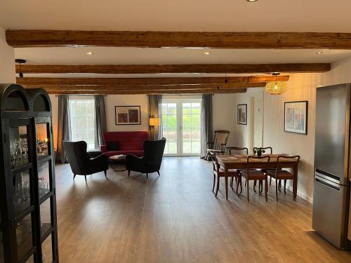 a living room with a table and chairs at Lindegaardens Bed and Breakfast in Viby