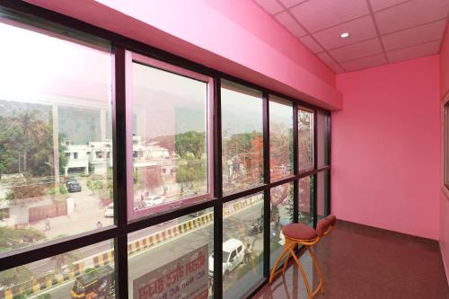 a room with pink walls and large windows at OYO SHRI RAM Homestay in Kāthgodām