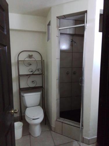 a bathroom with a toilet and a shower at Estancia la Ocho in Tijuana