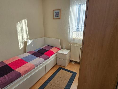 a small bedroom with a bed and a window at Gorgeous home with swimming pool and Jacuzzi Sea view ! in Boltenhagen