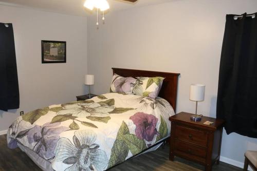 a bedroom with a bed and a night stand at Rt. 682 Athens, 3 Queen bedrooms, 2 baths, Wi-Fi in Athens