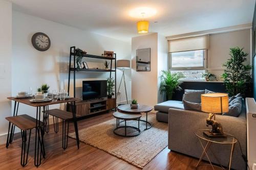 a living room with a couch and a table at Central Maidstone Contractor Flat in Maidstone