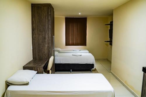 Posteľ alebo postele v izbe v ubytovaní Dom Quixote São Gonçalo Hotel