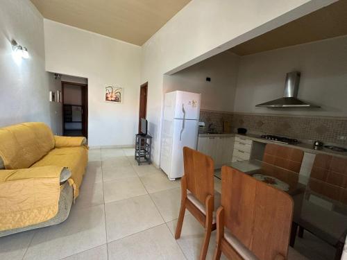 a living room with a couch and a kitchen at Casa Rosemary in Lauro de Freitas