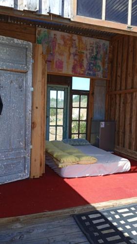 a room with two beds in a building with windows at Ladomar Cabañas in La Esmeralda 