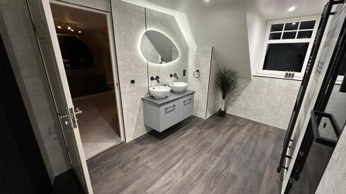 a bathroom with a sink and a mirror at The Gables Whisky B&B in Dufftown