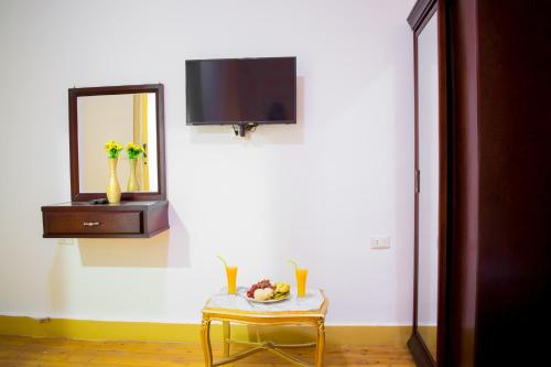 a white room with a table and a mirror and a chair at golden palace down town in Cairo