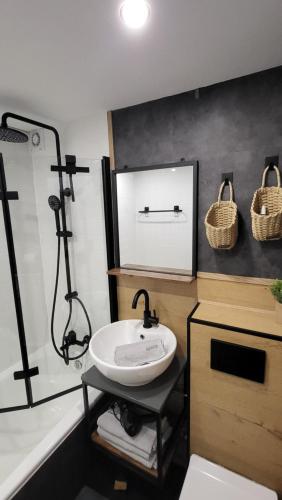 a bathroom with a sink and a shower at FeWo Gretel in Schönwald