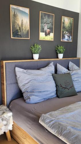 a bed in a bedroom with pictures on the wall at FeWo Gretel in Schönwald