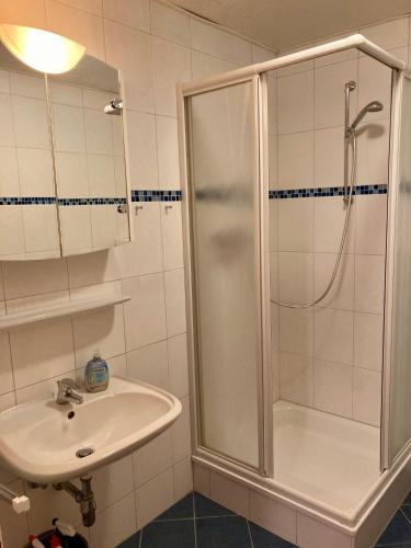 a bathroom with a shower and a sink at Nordsee 402 in Wangerooge