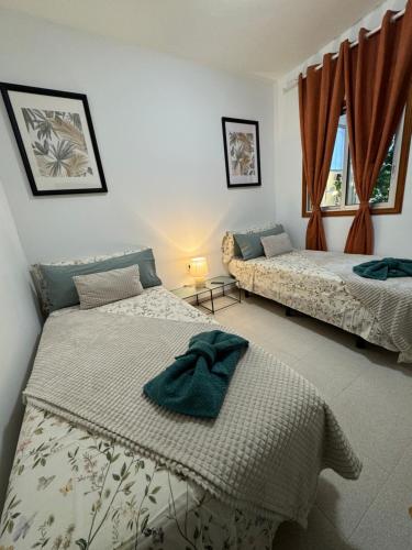 a bedroom with two beds and a window at DREAM MAJUELOS in Las Lagunas