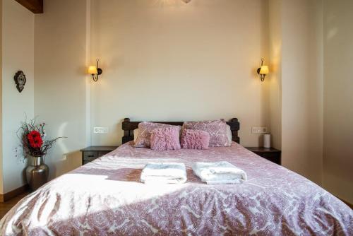 a bedroom with a large bed with two towels on it at Apartamentos Cangas Relax En Grupo in Cangas de Onís