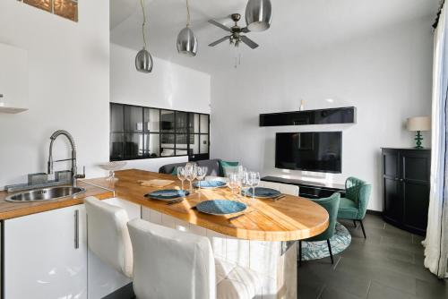 une cuisine avec une table en bois et quelques chaises dans l'établissement Appartement au cœur du Vieux-Port, à Marseille