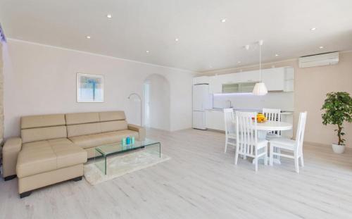 a living room with a couch and a table at Big Blue Apartments in Dubrovnik