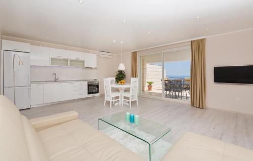 a living room with a white couch and a table at Big Blue Apartments in Dubrovnik