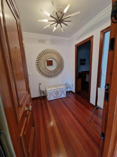a hallway with a ceiling fan and a mirror at Alojamiento Alameda in Redondela
