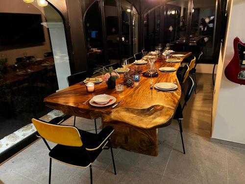 a long wooden table with chairs around it at Villa familiale avec vue imprenable in Saint-Raphaël