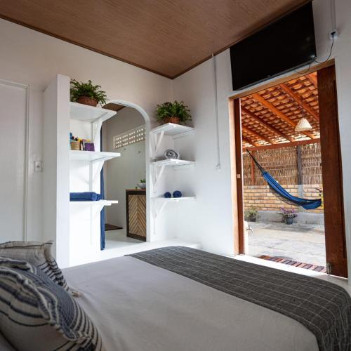 a bedroom with a bed and a large window at Casa aloha in Atins