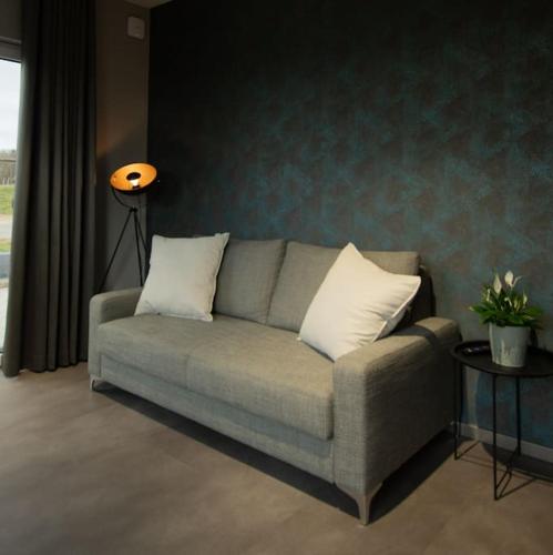 a couch with two pillows in a living room at Moderne Wohnung mit Panorama in Schneppenbach