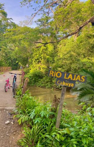 a bike parked next to a rio laws sign at Deer House Cabuya in Cabuya