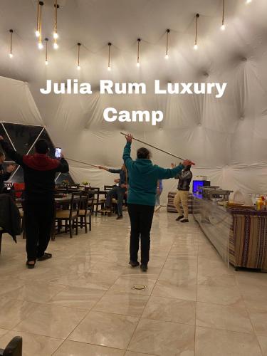 a group of people holding up a sign in a tent at Julia Rum Luxury Camp in Wadi Rum