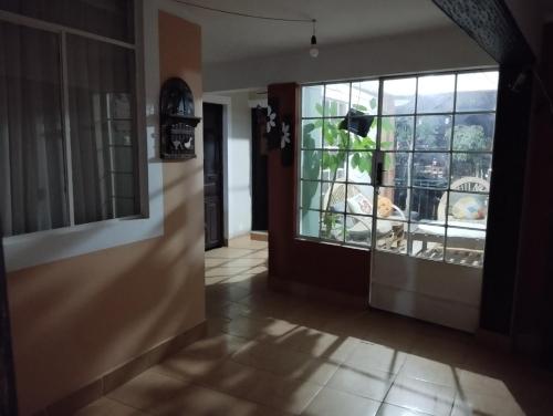 a hallway with a door and a large window at At Nativa in Sucre