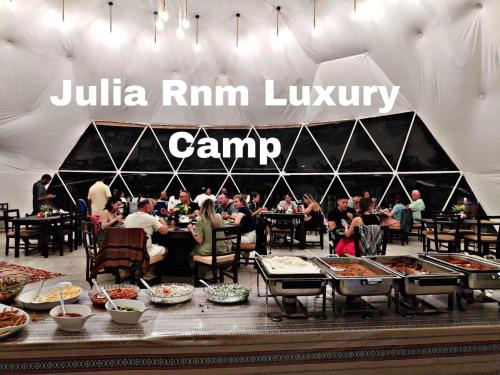 a crowd of people sitting at tables in a tent at Julia Rum Luxury Camp in Wadi Rum