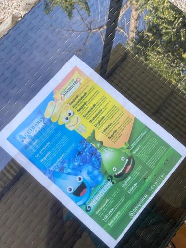 a poster on a bench with a frog on it at Deer House Cabuya in Cabuya